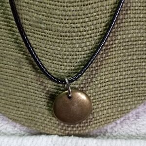 Goldtone round disk pendant on black cord necklace